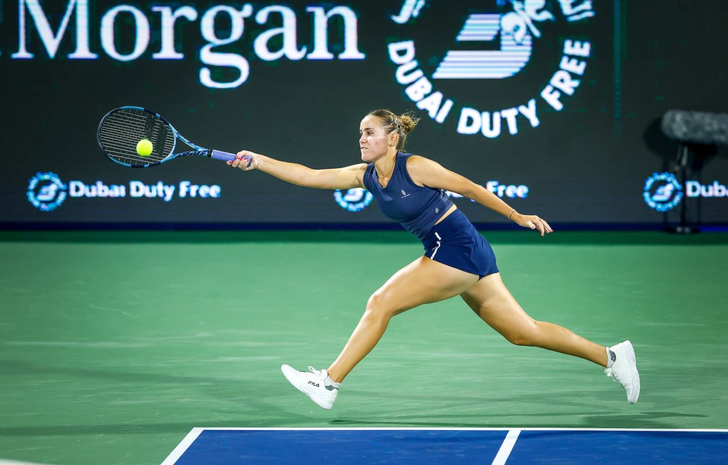 Sofia Kenin returning the ball during her match at Dubai 2025