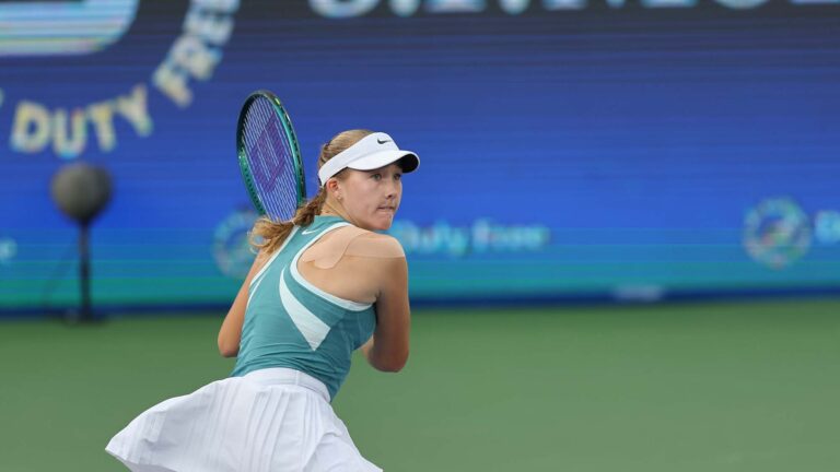 Mirra Andreeva preparing to return the ball during her match at Dubai 2025
