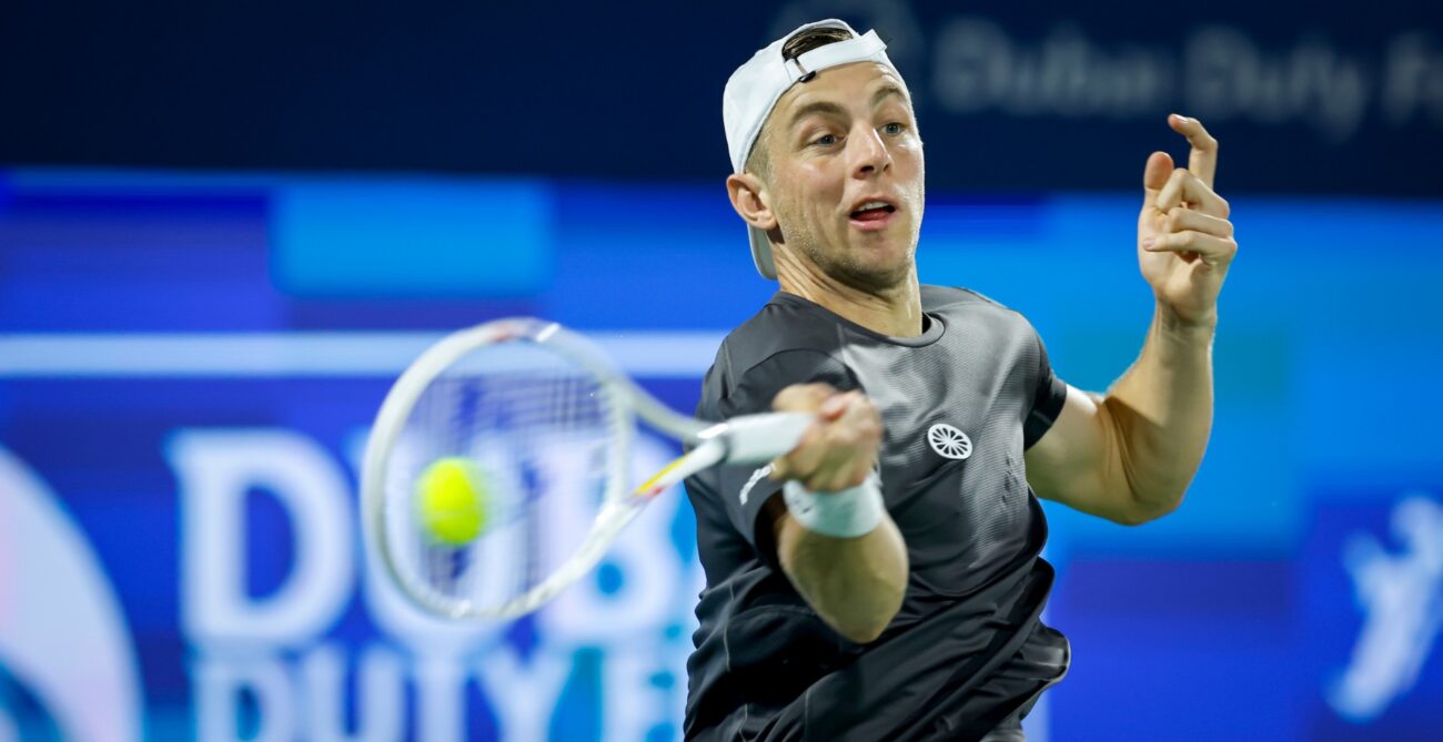 Tallon Griekspoor hitting the ball. His racquet is blurred.
