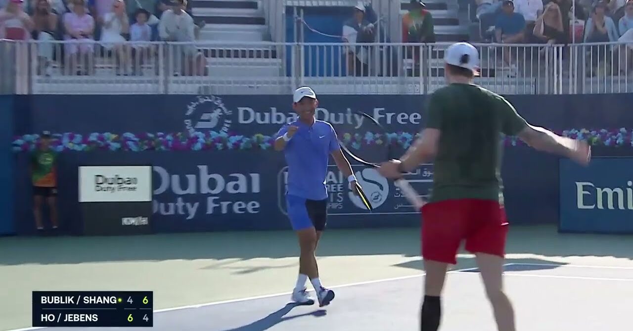 ATP doubles players celebrating with a high five after a point