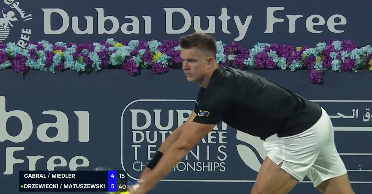 ATP player preparing to serve during a doubles match