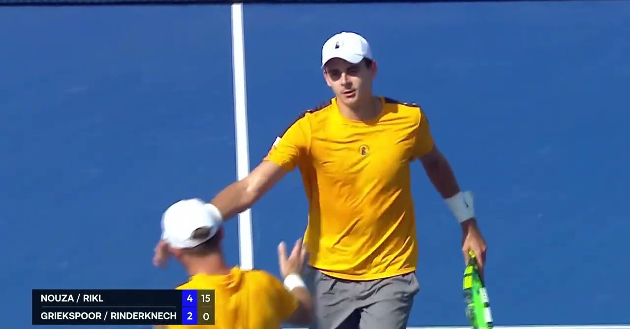 ATP doubles players high five on court