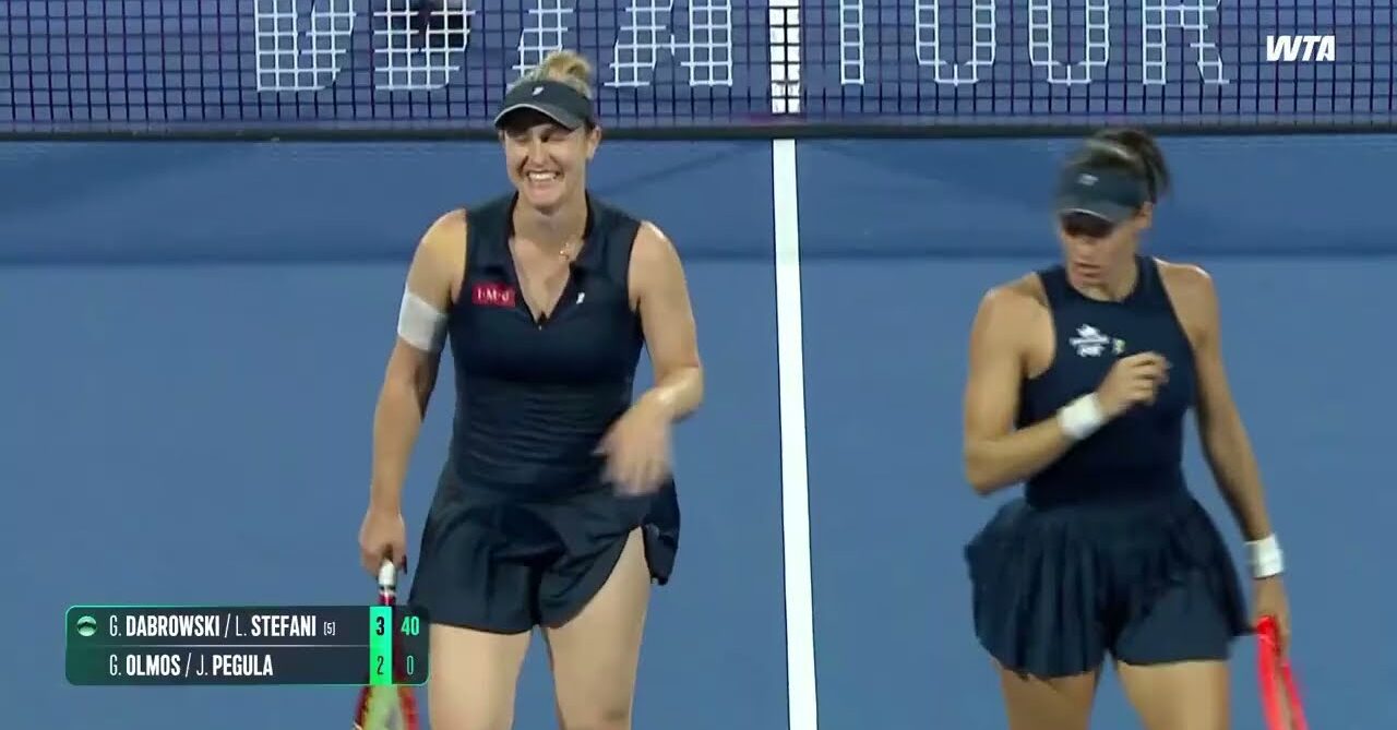 WTA Doubles players walk across court with smiles