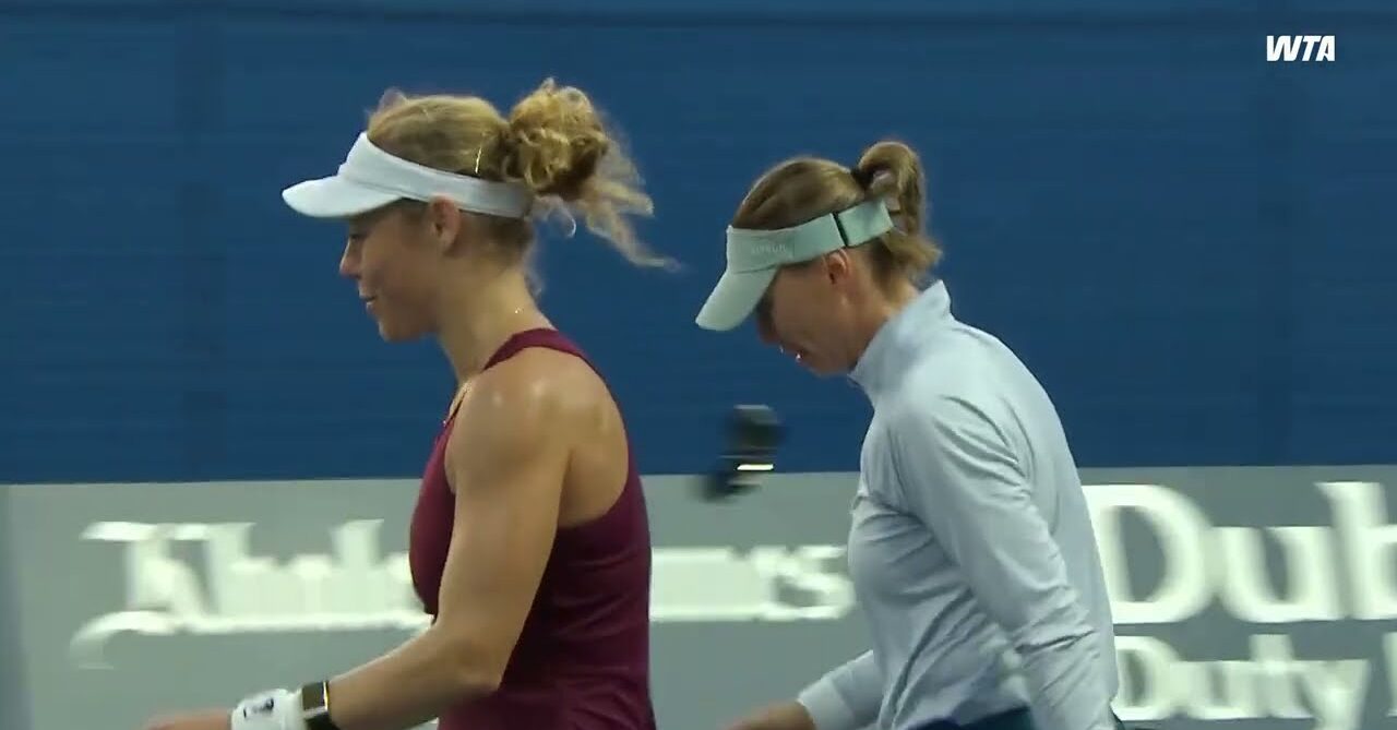 WTA doubles players walk across the court